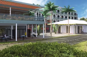 Marina à Baie Mahault, perspective de la façade à balcons de l'hôtel et d'un pavillon à toit blanc, avec des palmiers